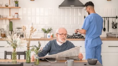 Elderly person waiting for his breakfast at the table